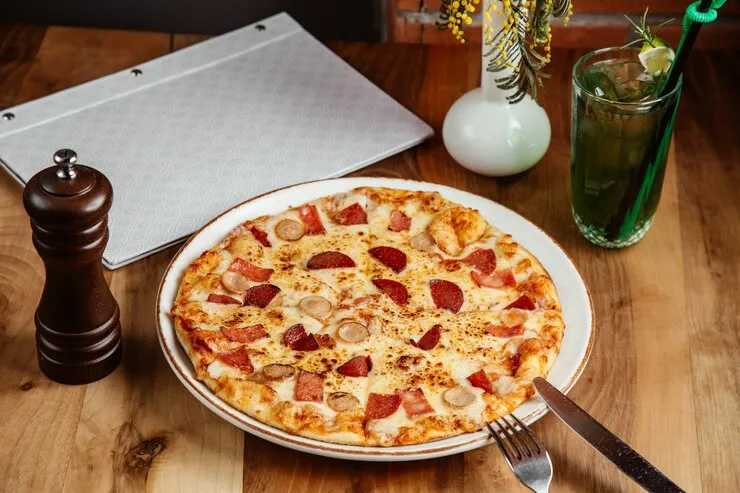 A pizza served on a platter.