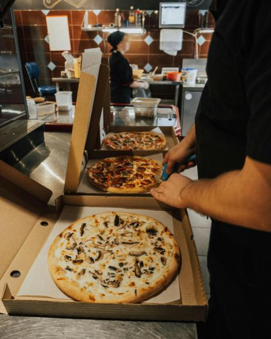 Fresh pizza prepared for reliable pizza delivery service in Chicago