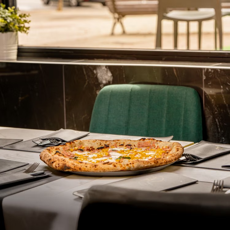Freshly baked pepperoni pizza served inside a cozy modern pizza place in Chicago