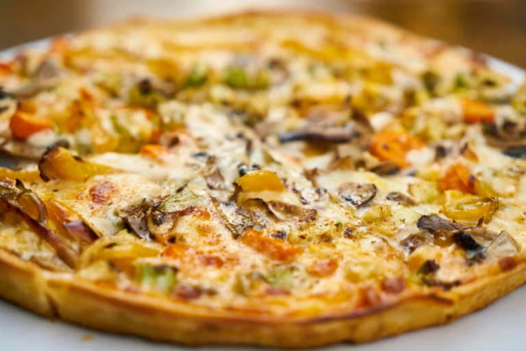 Freshly baked Chicago-style thin crust veggie pizza topped with mushrooms, bell peppers, and melted cheese.