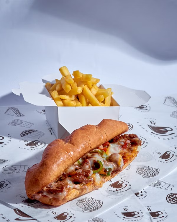 Italian beef sandwich with melted cheese served with crispy fries