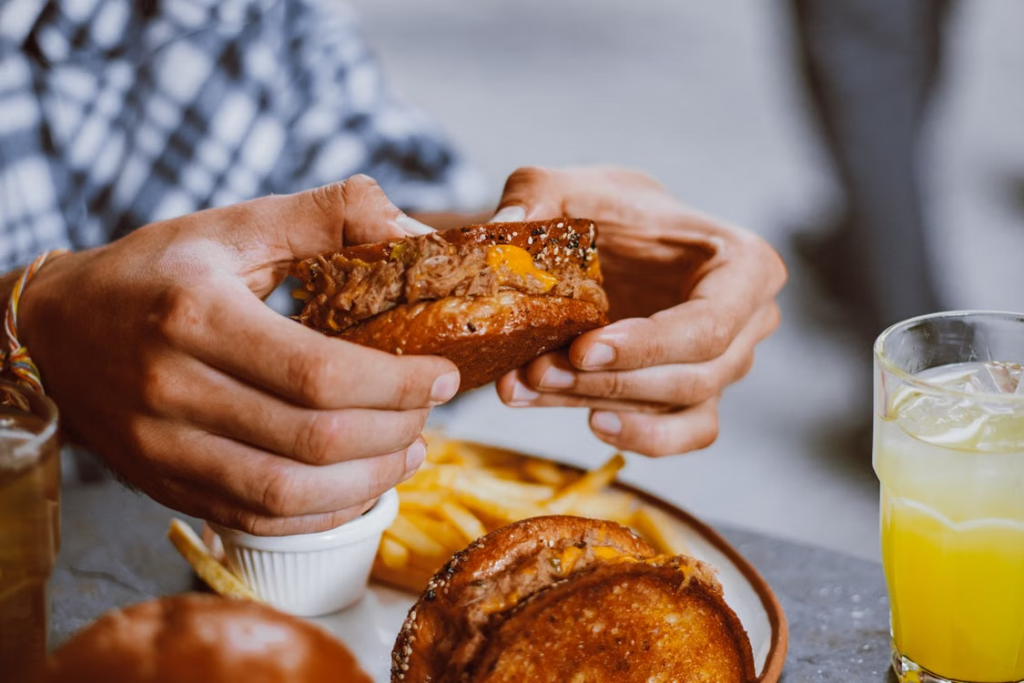 This photo shows a person holding a sandwich.