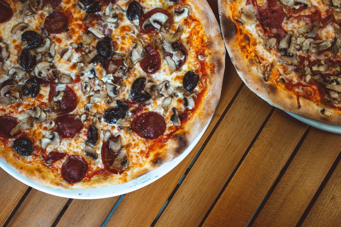 This photo shows a close-up of pizzas.