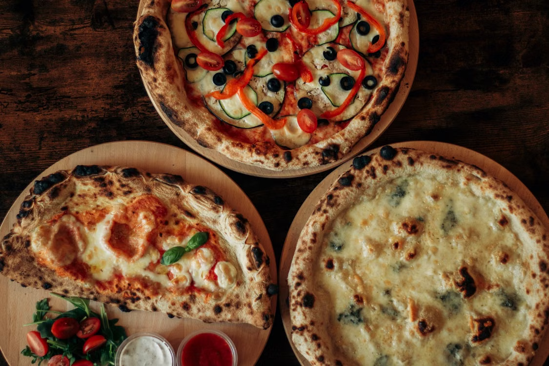 This photo shows an assortment of pizzas.